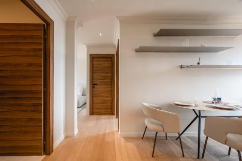 a dining room with a table and chairs at Le Nid du Favre II - Large 2 room with breathtaking view of the lake in Annecy