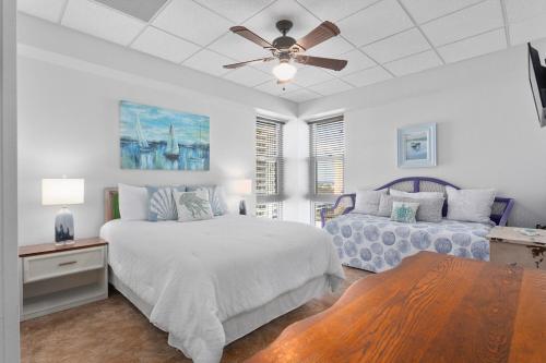a bedroom with two beds and a ceiling fan at Ocean Front Penthouse Suite Panoramic Views of Gulf,Pensacola Beach,Pier, & Bay in Pensacola Beach