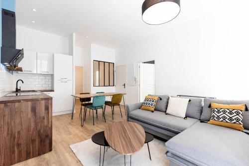 un salon avec un canapé et une table dans l'établissement Castellane centre ville : Deux Chambres, à Marseille