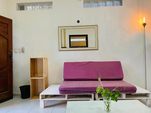 a purple couch sitting on a table in a room at Anana Coliving in Playa del Carmen