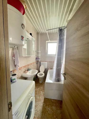 a bathroom with a sink and a toilet and a tub at Apartman Guberinic,Tivat ,trosoban stan in Tivat