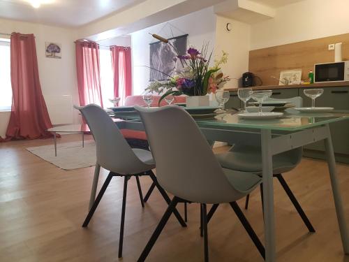 a dining room with a green table and chairs at St junien n:2 in Saint-Junien