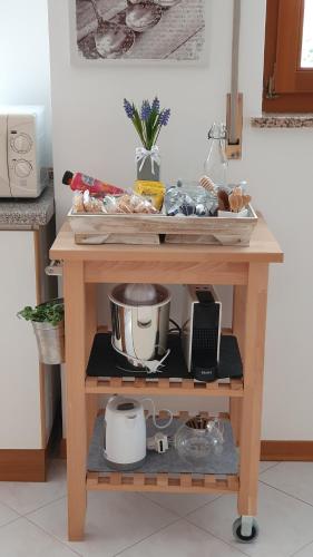 a small wooden cart with food on it at Casa Hueller in Roncegno