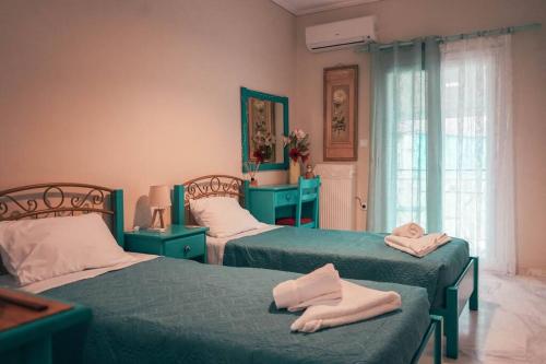 a bedroom with two beds with towels on them at Mojo Studios Parga in Parga