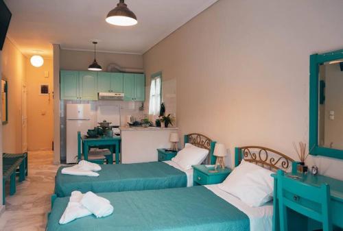 a living room with two beds and a kitchen at Mojo Studios Parga in Parga