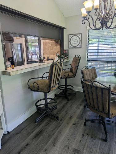 a dining room with chairs and a table and a mirror at Lake ConRoy Estates - Unit A with Pool Access in Montgomery