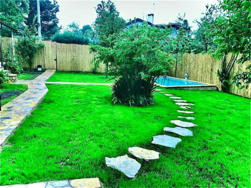 a garden with a tree and rocks in the grass at ASYA HOME in Kocaeli
