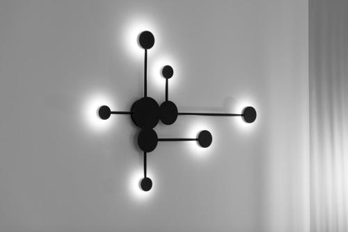 a black clock on a white background at Bella Vasilica Luxury Apartments in Parga