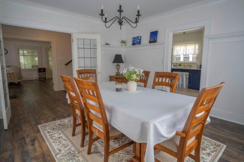 a dining room with a white table and chairs at U-District Warmth 8 mins walk to UW in Seattle