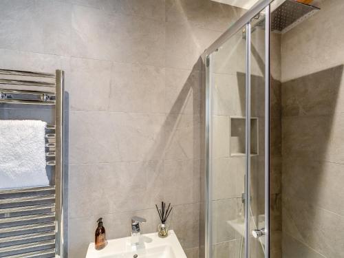 a bathroom with a sink and a shower at The Mill Townhouse in Pateley Bridge