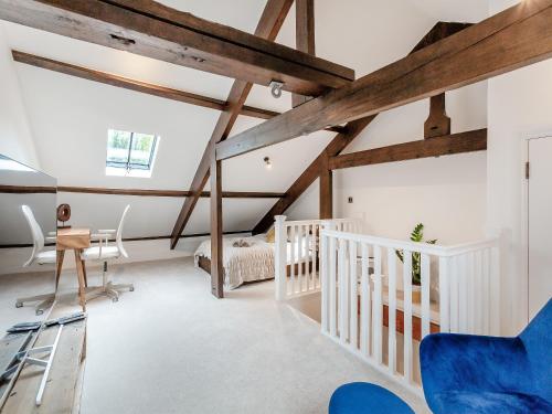 a room with white walls and wooden beams at The Mill Townhouse in Pateley Bridge