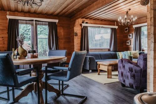 a living room with a table and chairs at Cosy and Romantic forest house met SAUNA op de Veluwe in Putten