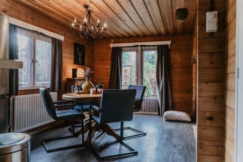 a dining room with a table and chairs at Cosy and Romantic forest house met SAUNA op de Veluwe in Putten