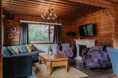 a living room with a couch and a table at Cosy and Romantic forest house met SAUNA op de Veluwe in Putten