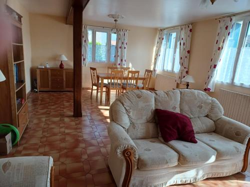 a living room with a couch and a table at 9 Guests - Pet Friendly in rural West France in Clussais-la-Pommeraie