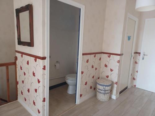 a bathroom with a toilet and a door with hearts on the wall at 9 Guests - Pet Friendly in rural West France in Clussais-la-Pommeraie
