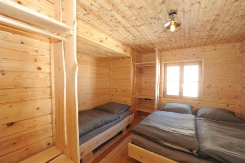a log cabin with two bunk beds in it at Ferienhof Holzmeister in Sankt Jakob in Haus