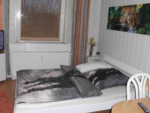 a bed with pillows on it in a room at Lovely Apartment 2 Et Inkl Parkplatz nach Verfügbarkeit in Essen