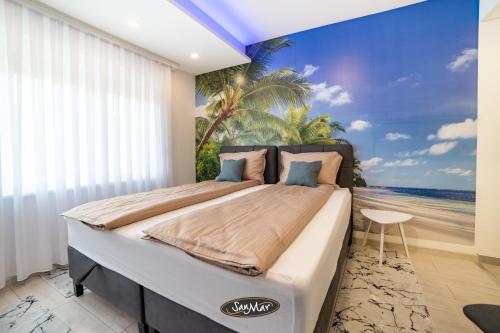 a bedroom with a bed with a view of the beach at San-Mar Apartments in Tuzla