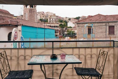 a table and two chairs sitting on a balcony at Mojo Studios Parga in Parga