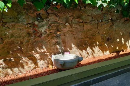 a toilet sitting in front of a stone wall at Beautiful Villa with Garden Princess Islands in Istanbul