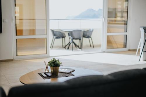 a living room with a table and chairs at MonteCasa Seaview Rooms in Dobra Voda