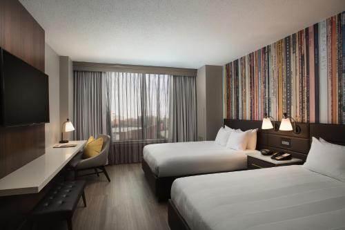 a hotel room with two beds and a desk at Nashville Marriott at Vanderbilt University in Nashville