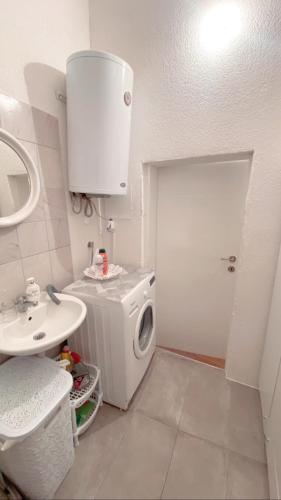 a bathroom with a washing machine and a sink at Galeb Apartment Ohrid in Ohrid
