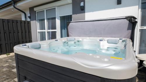 a hot tub sitting outside of a house at River&Lake Luxury I. Apartman in Sárvár