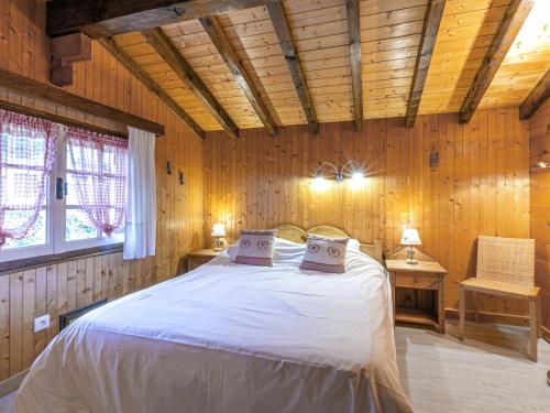 a bedroom with a bed in a wooden room at Chalet La Clusaz, 4 pièces, 6 personnes - FR-1-437-33 in La Clusaz