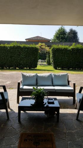 a couch sitting on a patio with a table at Cavour 45 in Vittuone