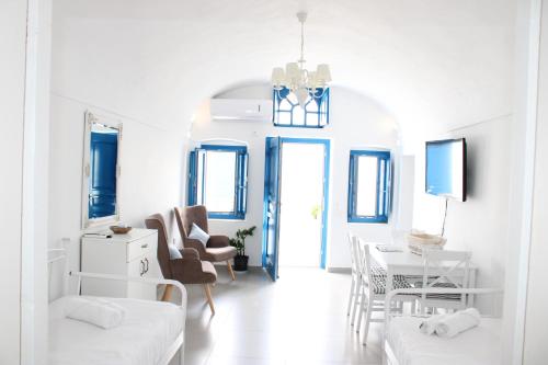 a white living room with a table and chairs at Mary Castelia Villa 2 with Jacuzzi in Akrotiri