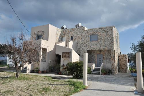 a large white building with a lot of windows at Blue Wave in Kefalos
