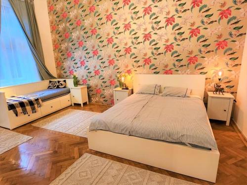 a bedroom with a bed and a floral wallpaper at NEW LISTING IN THE HEART OF BUDAPEST Apartment Kamilla in Budapest