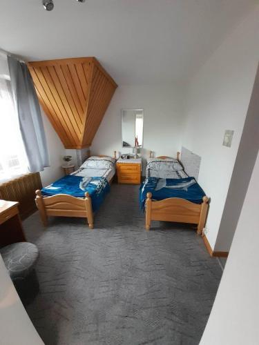 a room with two beds in a room at Lila in Bukowina Tatrzańska