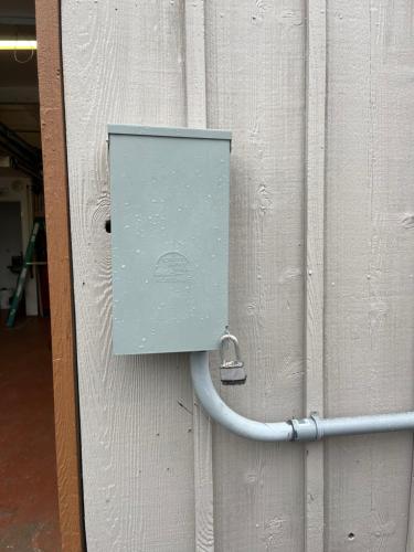 a door with a blue box on a wall at Creekside Downtown Vacation Suites, Only Adults 25 or older in Buffalo
