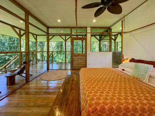 a bedroom with a bed and a ceiling fan at Casa Cayuco Eco-Adventure Lodge in Bocas del Toro