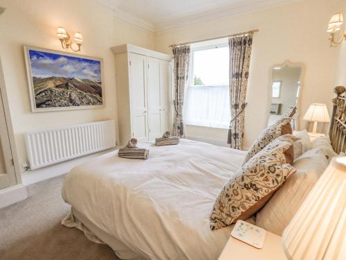 a bedroom with a large bed and a window at Grisedale View in Keswick