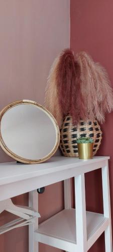 a table with a mirror and baskets on it at BnB Antwerp - BOUTIQUE in Antwerp