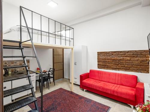 a living room with a red couch and a loft at The Red Tent Suite 88 in Istanbul