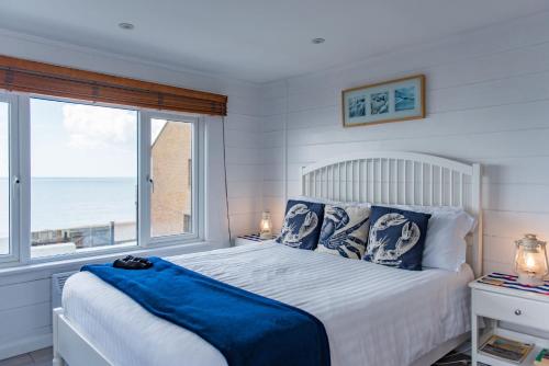 a bedroom with a bed with a view of the ocean at Pebbles by Bloom Stays in Sandgate