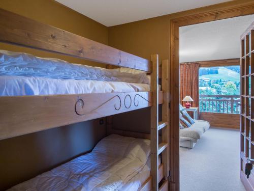 two bunk beds in a room with a balcony at Studio Megève, 1 pièce, 4 personnes - FR-1-453-73 in Megève
