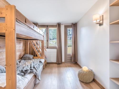 a bedroom with a bunk bed and a large window at Appartement 3 pièces au centre de Megève, balcon, proche télécabine, Wifi, idéal pour 4 personnes - FR-1-453-53 in Megève