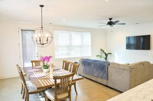 a living room with a table and a couch at Modern Midtown home with 3 king beds in Memphis