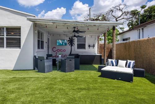 a pergola with a couch and a table on a lawn at Coco Loco - Little Havana in Miami