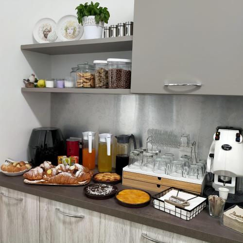 a kitchen counter with plates of food on it at B&B MANDORLO BIANCO in Avola