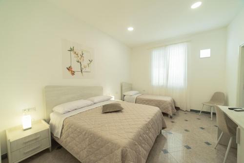 Postel nebo postele na pokoji v ubytování B&B MANDORLO BIANCO