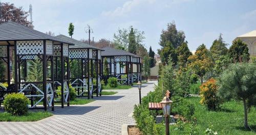 a park with a pavilion and a bench and trees at Sun City Hotel & Spa Naftalan in Naftalan