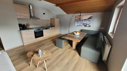 a small kitchen and dining room with a table and a couch at Haus Grübl in Wald im Pinzgau