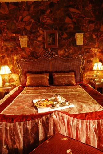 a bed with a tray of food on it at Oriental Rivoli Hotel & Spa in Sharm El Sheikh